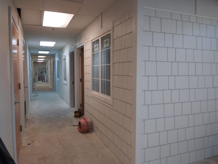 Unfinished hallway in a building.