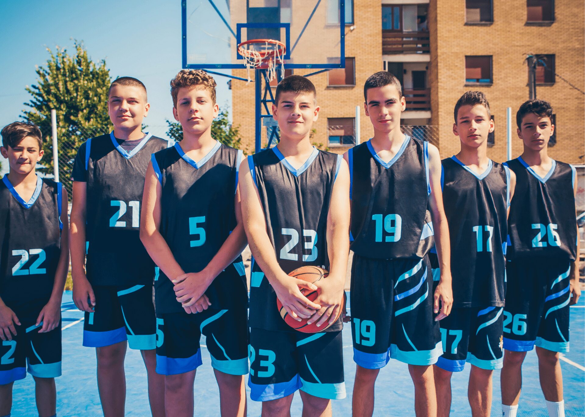 Group of young basketball players posing