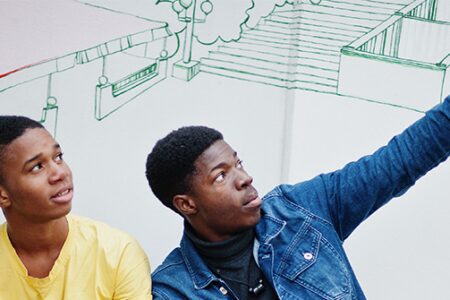 Two young men looking upward.