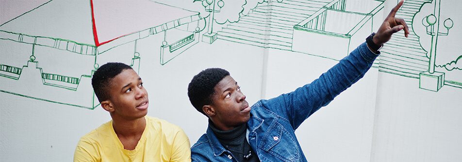 Two young men looking upward.