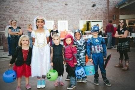 Young kids in costumes posing for a photo.