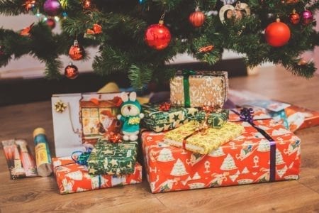 Christmas gifts under a tree.