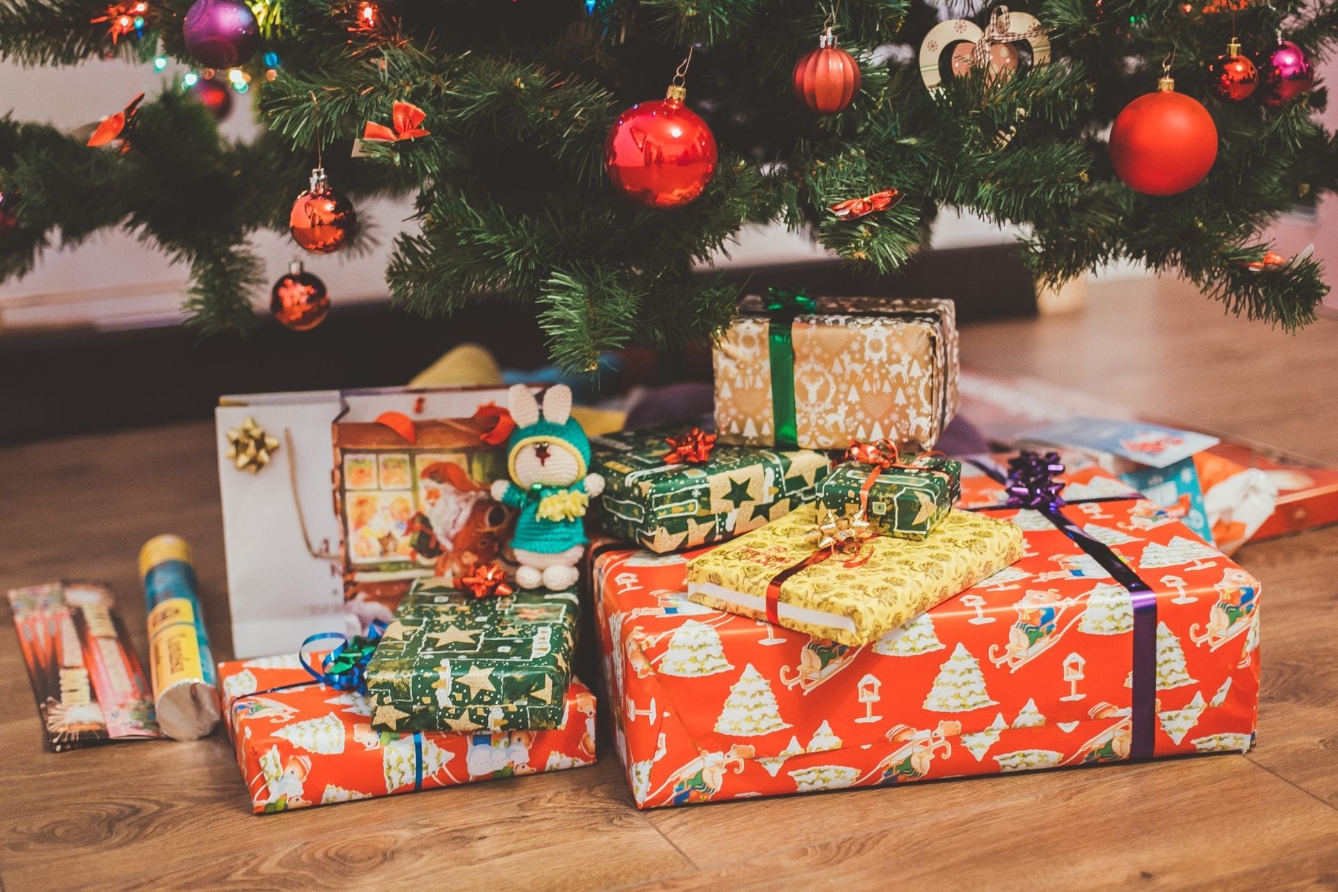 Christmas gifts under a tree.