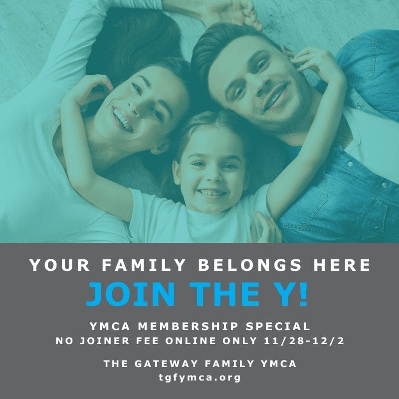 A family photo with a YMCA membership sign in front.