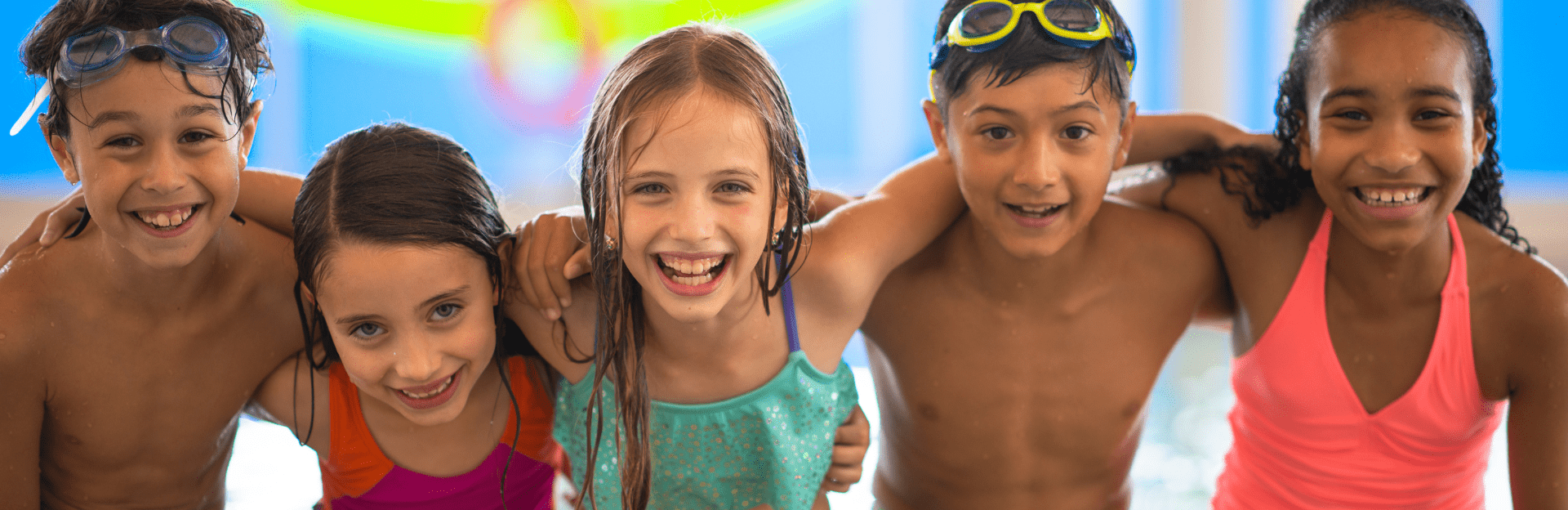 Five smiling children at pool