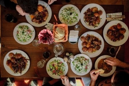 A long table with many plates of food.