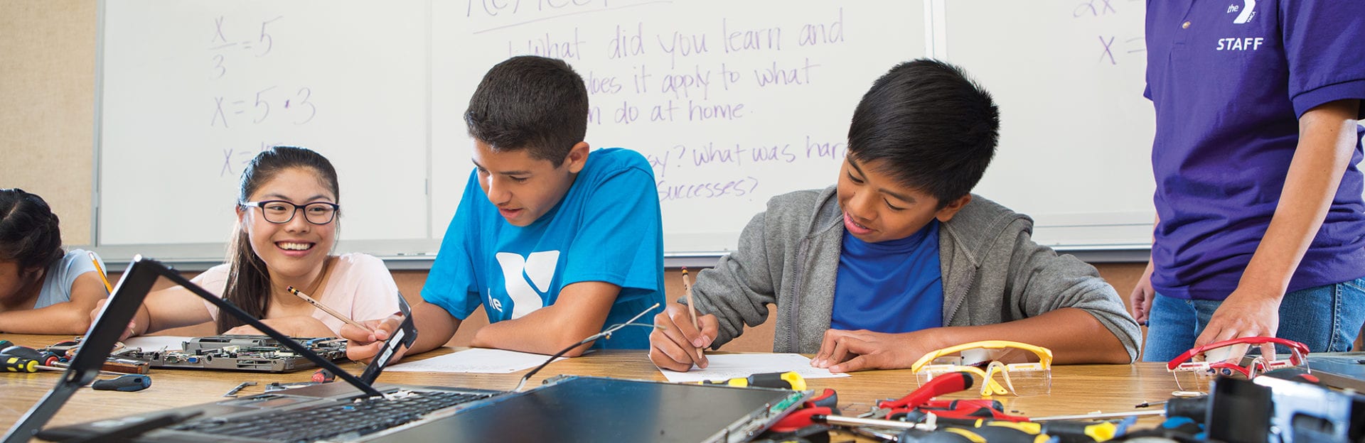 Children at a table in a classroom.