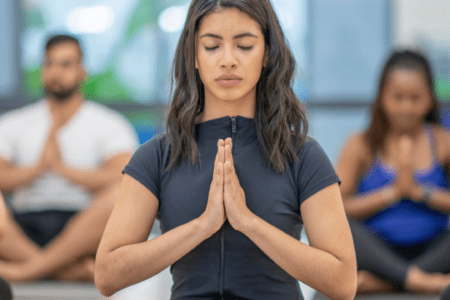 Group practicing yoga in meditation