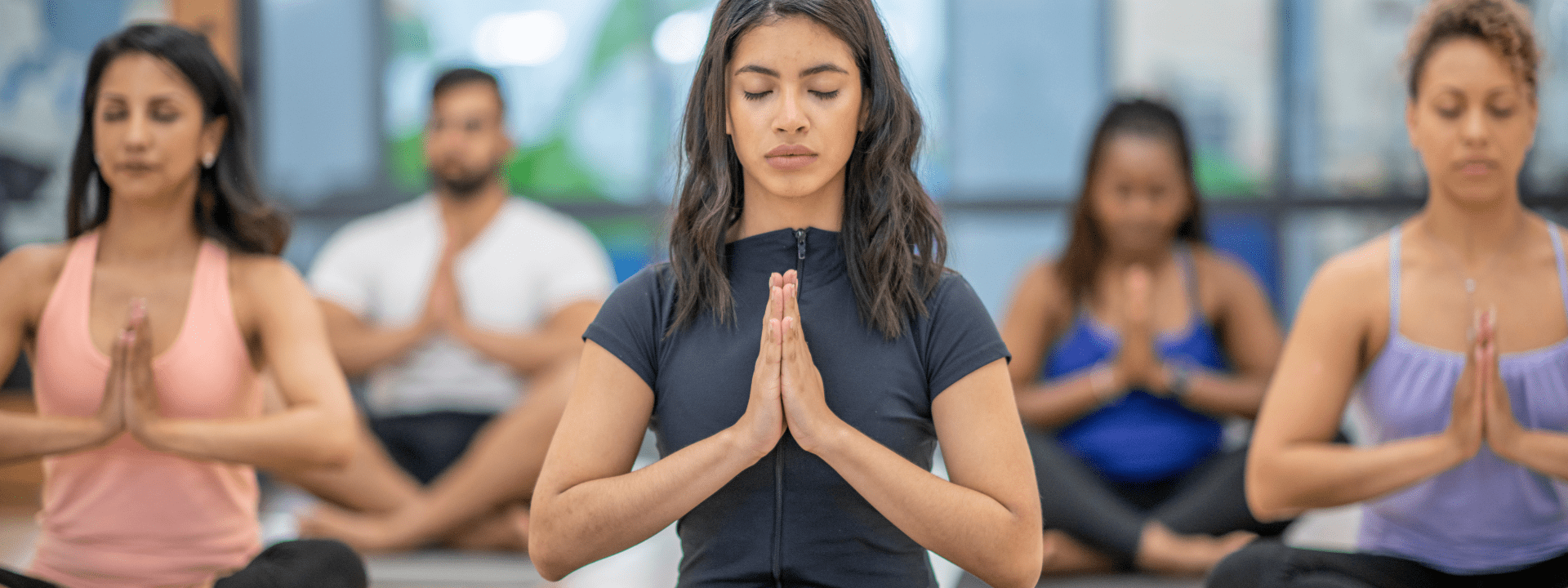Group practicing yoga in meditation